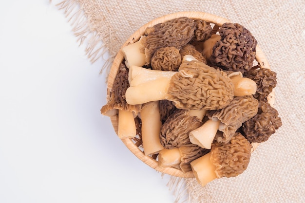 Wicker basket with morel mushrooms top view