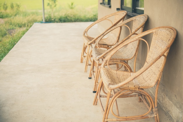 Wicker rattan chair on balcony terrace patio for resting near garden