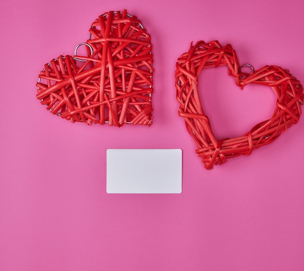 Wicker red heart and empty blank paper business card