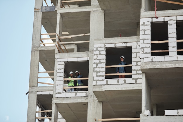 Wide angle background image of high rise construction site copy space