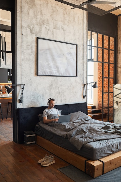 Wide Angle Man Relaxing in Bed