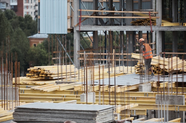 Wide angle view at construction site with metal and concrete structures, copy space