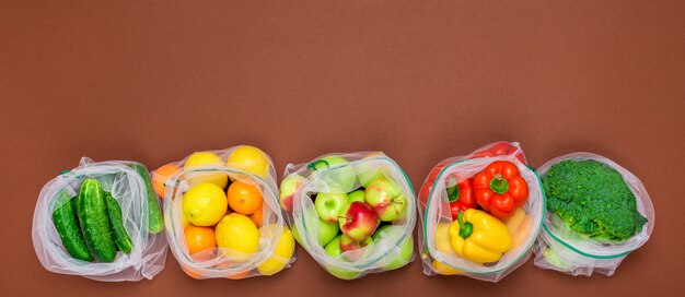 Wide banner. Fresh and juicy fruits and vegetables in reusable eco-friendly mesh bags.