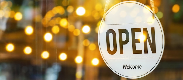 Wide banner. Lift lockdown. Open sign board hanging on glass door in cafe coffee shop, quarantine, cafe restaurant, retail store, small business owner, takeaway food, food and drink concept