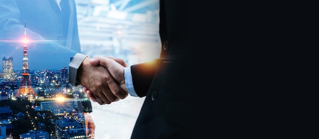 Wide banner. multi exposure image of investor business man handshake with partner for successful meeting deal with during sunrise and cityscape background, investment, partnership, teamwork concept