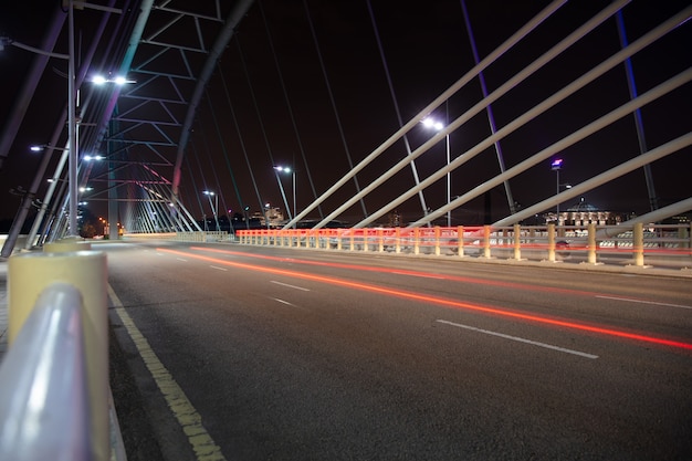 Wide night asphalt road on the bridge background