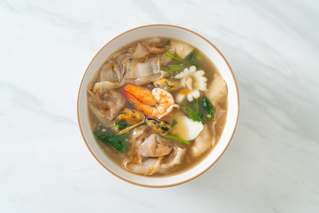 Wide Rice Noodles with Seafood in Gravy Sauce - Asian food style