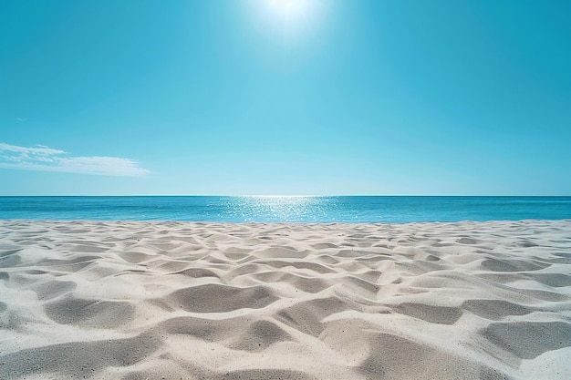 A wide shot of an empty sandy beach with a clear blue sky the very fine and smooth sand without an