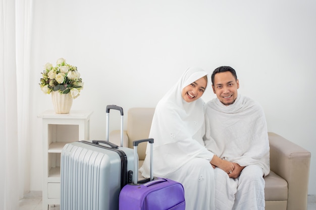 Wife and husband in white traditional clothes for Ihram