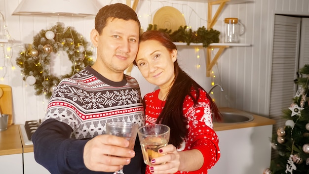 Wife and husband with glasses of champagne congratulate