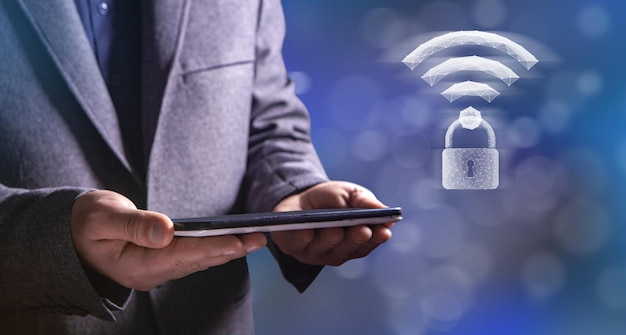 WiFi and lock from the network Man holding a tablet in his hand