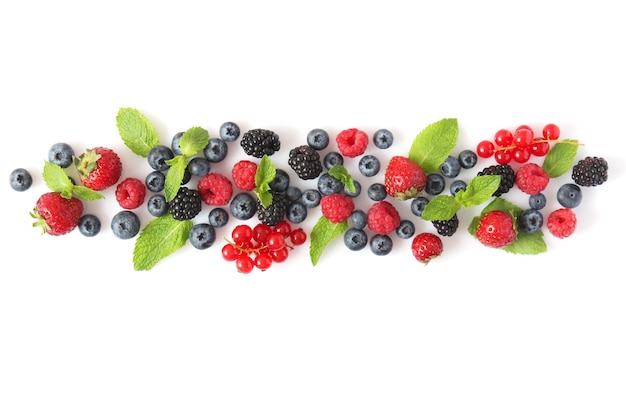 Wild berries and mint leaves on a white background top view