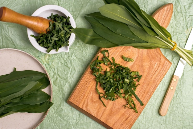 Wild garlic Wild garlic on a wooden board on a green background