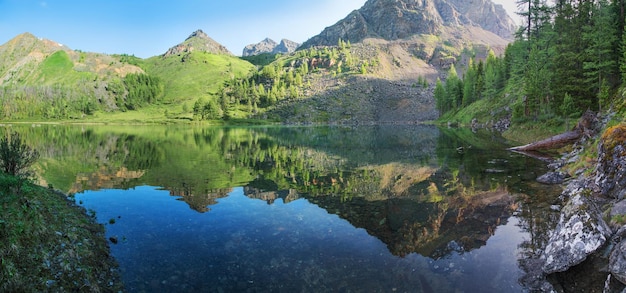 Wild lake in the Altai mountains on a summer morning, picturesque reflection