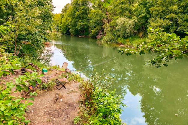 A wild place on the bank of a forest river prepared for fishing