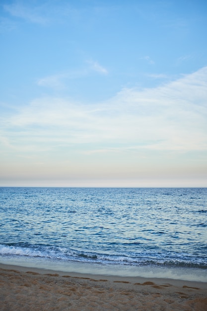 Wild swimming beach without people after sunset without sun