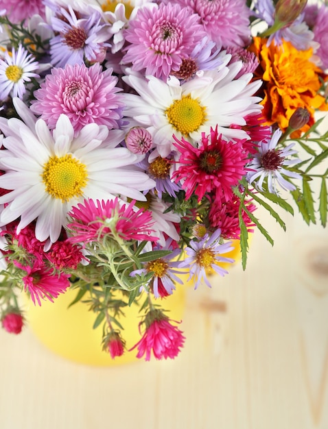 Wildflowers in mug on wooden table