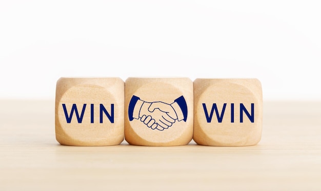 Win Win concept Text and handshake Icon on wooden blocks Copy space