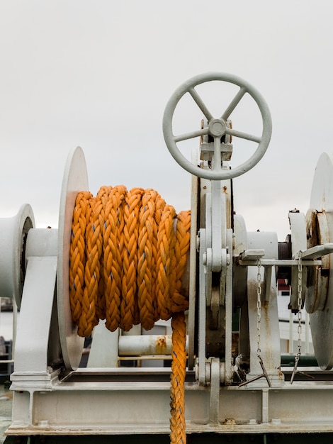 Winch with orange rope on a ferry