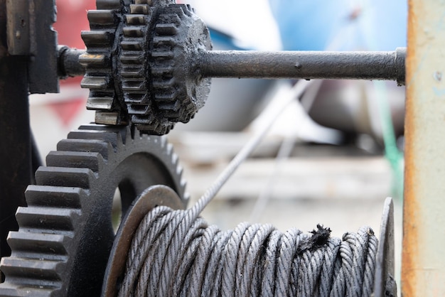 Winch with a rope on a pier with boats and boats against the sky