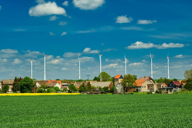 Wind electric turbines in agricultural wheat field in countryside Deutchland