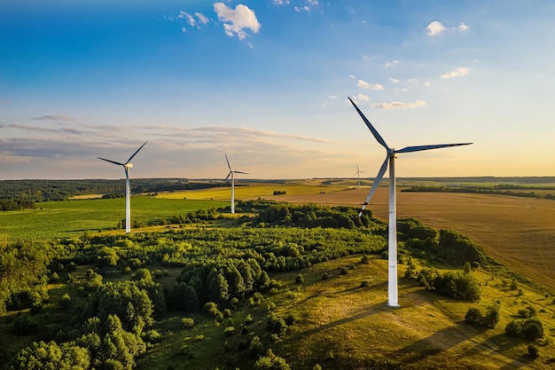 Wind generators on the background of the setting sun top view from a drone