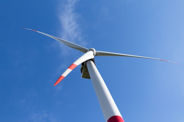 Wind turbine against blue sky, alternative energy source concept