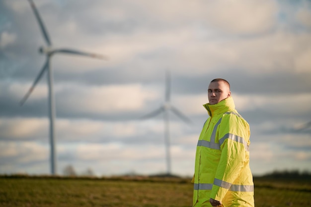 Wind turbine worker in the field Concept of green energy Male engineer working