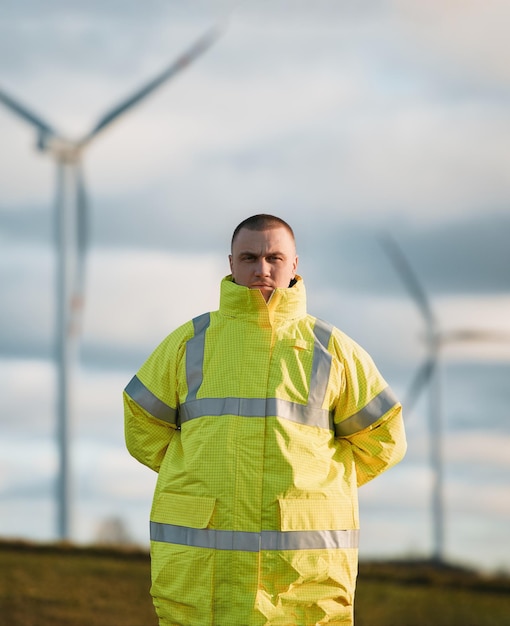 Wind turbine worker in the field Concept of green energy Male engineer working