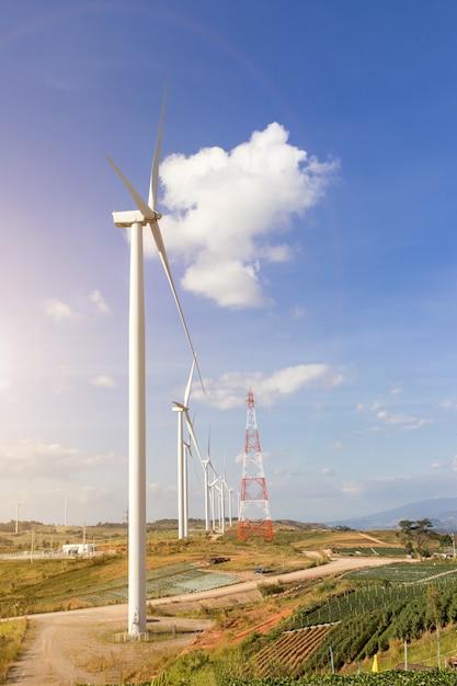 Wind turbines farm on mountanis landscape against blue sky with clouds background,Windmills for electric power ecology concept