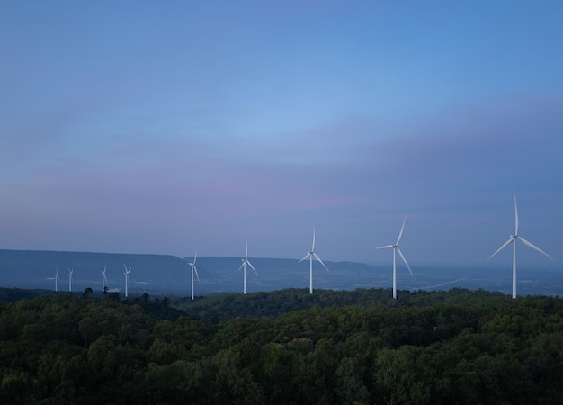 Wind turbines farm on sunset in winter