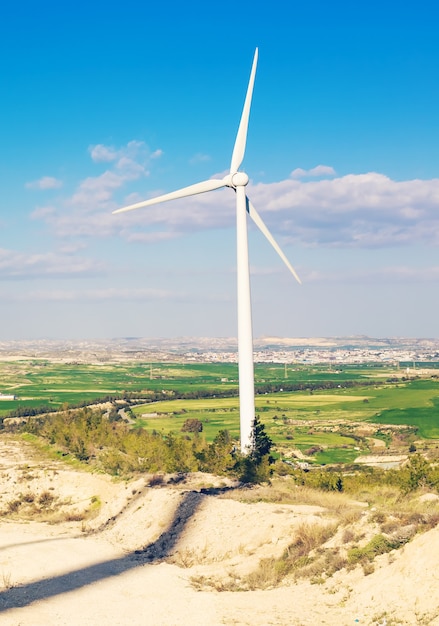 Wind turbines generating electricity with blue sky - energy conservation concept.