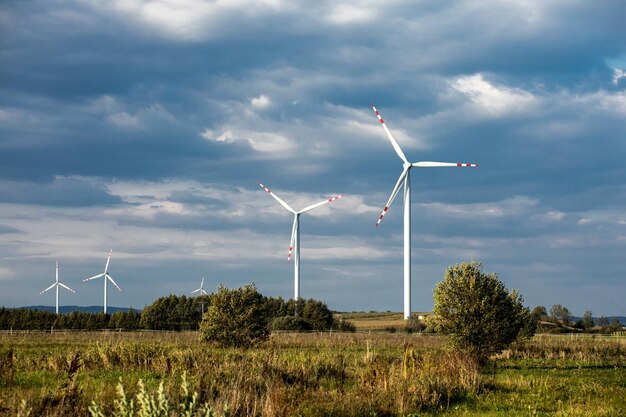 Wind turbines on green hills Group of windmills for electric power production in the green