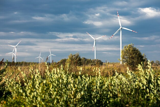 Wind turbines on green hills Group of windmills for electric power production in the green