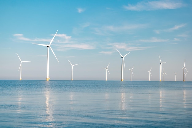 Wind turbines in sea against sky