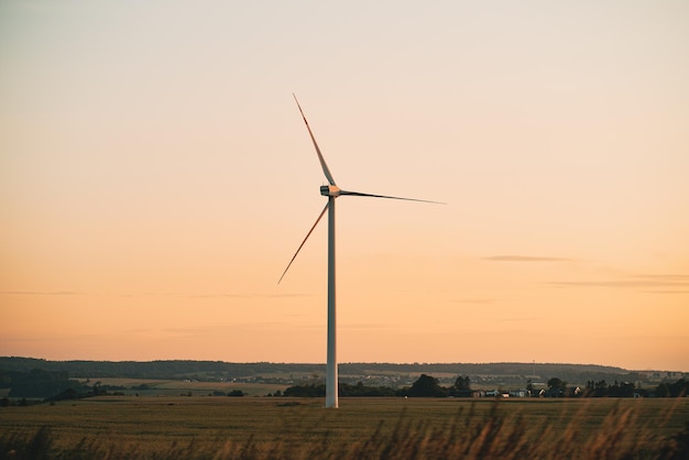 Wind turbines during sunrise Wind farm view at sunset