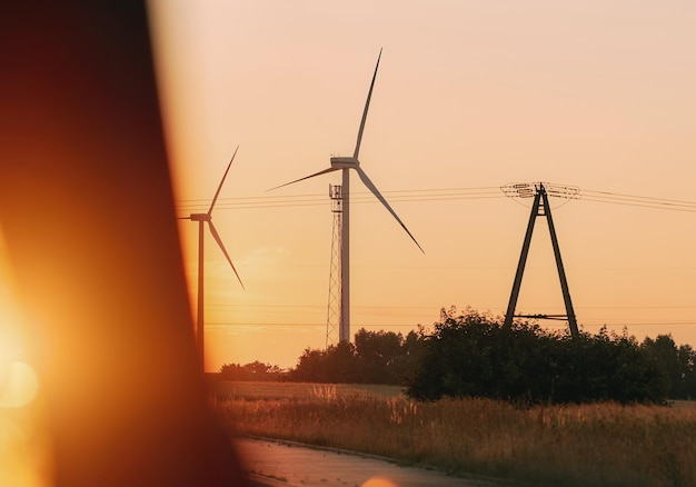 Wind turbines during sunrise Wind farm view at sunset