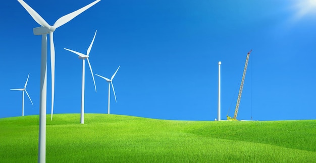 Windfarm in a field of green grass with construction crane installing wind turbine against blue sky