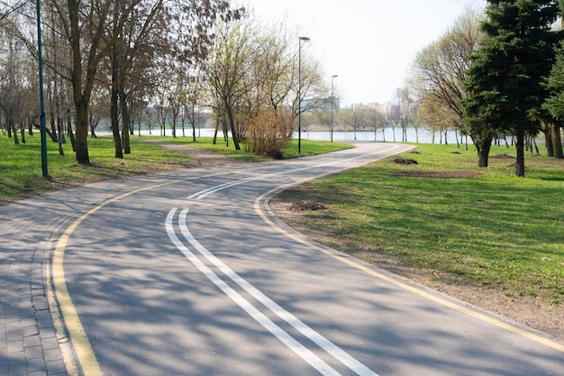 A winding bike path combined with a footpath passing through the city along the river healthy lifestyle walks fresh air