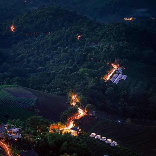 Winding mountain road with Long exposure traillight tracks from cars at the dusk