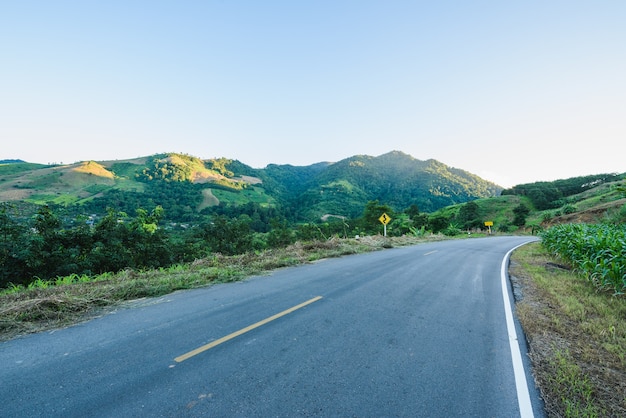 Winding road mountain blue sky