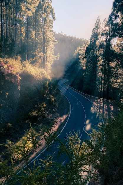 Winding road in the mountain with sun rays illuminating