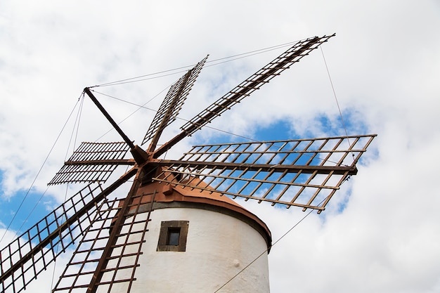 Windmill on cloudy sky