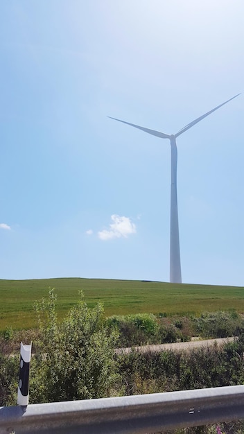 Windmill on field against sky