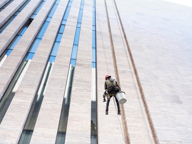 Window cleaner is working on the office building