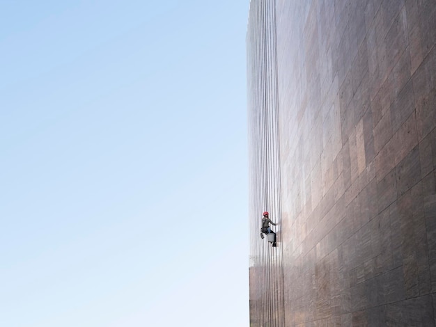 Window cleaner is working on the office building