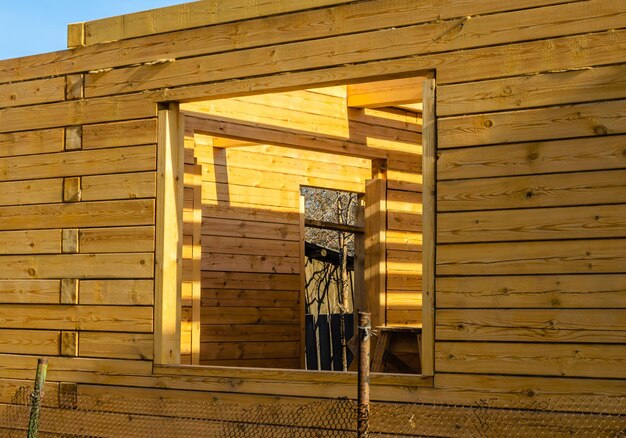 Window opening in an unfinished house made of timber.