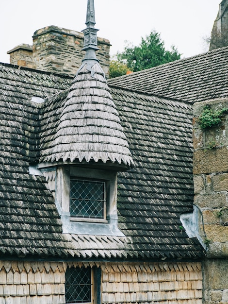 Window protruding between roof tiles, medieval house roofs