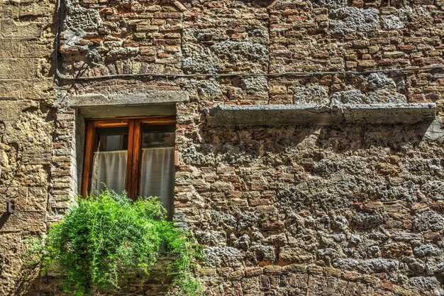 Window in a rustic facade in San Gimignano Sardinia