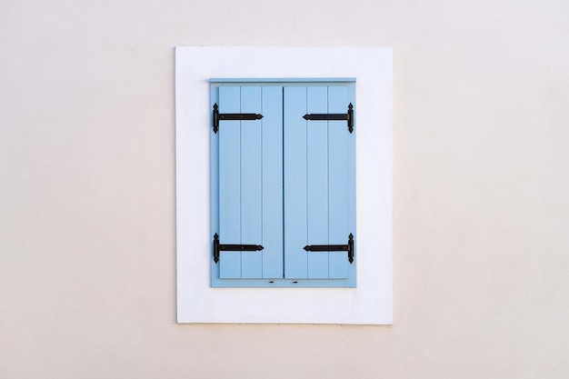 Window with blue shutters Architectural composition Closed window Design and ideas